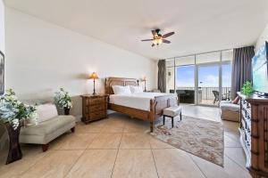 a large bedroom with a bed and a balcony at Turquoise Place 408C in Orange Beach