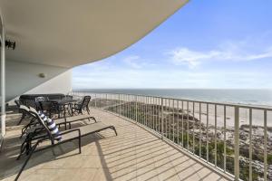 a balcony with chairs and a view of the ocean at Turquoise Place 408C in Orange Beach