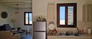a kitchen with a stainless steel refrigerator and a couch at Kea's Hidden Diamond in Otziás