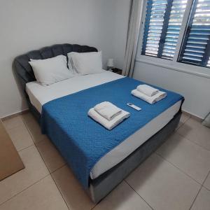 a bed with towels on top of it in a room at Horizon Bliss at Coral Bay in Peyia +34 photos