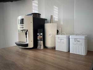 a coffee machine sitting on top of a wooden floor at Apartamenty AP 1 in Częstochowa