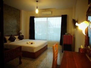 Postel nebo postele na pokoji v ubytování รีสอร์ทที่ลำปาง (Resort At Lampang)