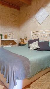 a bedroom with a large bed with blue sheets at Casa Estrella in Villafamés +59 photos