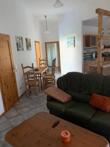 a living room with a couch and a table at Pension Horn in Schkopau