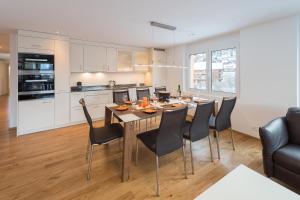 a kitchen and dining room with a table and chairs at Millegga Grächen in Grächen