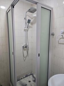 a shower with a glass door in a bathroom at My Flat 0 in Praia +25 photos