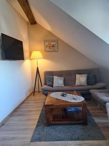 a living room with a couch and a coffee table at Apartamenty Przy Farze in Kazimierz Dolny