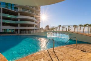 a swimming pool in front of a building at Turquoise Place 408C in Orange Beach