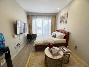 a hotel room with a bed and a table at Studio near JKIA and SGR Syokimau in Nairobi
