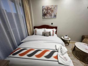 a bedroom with a bed with a blanket on it at Studio near JKIA and SGR Syokimau in Nairobi +17 photos