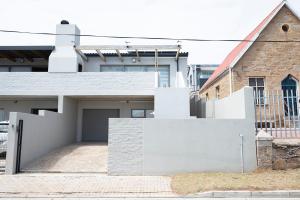 a house with a white fence in front of it at Unwinding Mossel bay in Mossel Bay