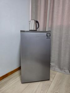 a refrigerator with a tea kettle on top of it at Hotel El-Shaday in Vila Nova do Sul