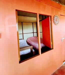 a mirror in a room with a bunk bed at Nuwakot Hills Farmstay in Trisūli Bāzār