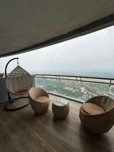 a room with three chairs and a large window at Spira staycation in New Delhi
