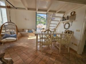 a living room with a table and chairs at Bell' Antonio Sea View in Minori