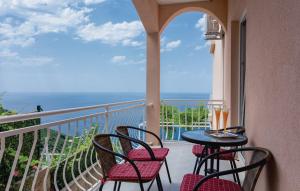 a balcony with a table and chairs and the ocean at Vista Apartments in Cavtat