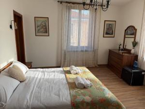 a bedroom with a bed with two towels on it at "The Moment"- rooms Bergamo center, self check-in, late Arrivals in Bergamo +52 photos