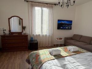 a bedroom with a bed and a couch and a mirror at "The Moment"- rooms Bergamo center, self check-in, late Arrivals in Bergamo