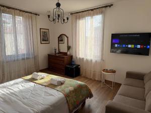 a bedroom with a bed and a flat screen tv at "The Moment"- rooms Bergamo center, self check-in, late Arrivals in Bergamo