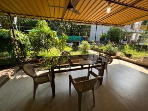 a glass table and chairs on a patio at Beach Side Home Stay - Kihim in Kīhīm