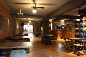 a restaurant with tables and chairs and a brick wall at Kuzen Otel in Istanbul