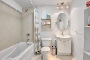 a bathroom with a tub and a toilet and a sink at A very peaceful home in Oshawa