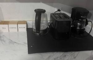 a counter with a coffee maker and a blender on it at A very peaceful home in Oshawa +5 photos