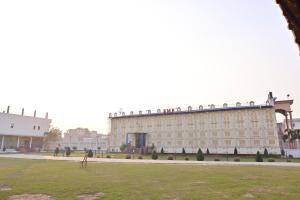 a large building with people sitting on top of it at Royal Mac Palace in Motīhāri