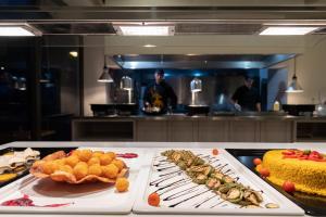 a table with several different types of food in a kitchen at Ariadne Beach - Adults Only in Agios Nikolaos