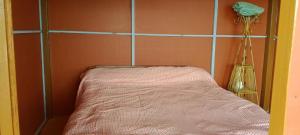 a bed in a room with a wall at Nuwakot Hills Farmstay in Trisūli Bāzār +15 photos