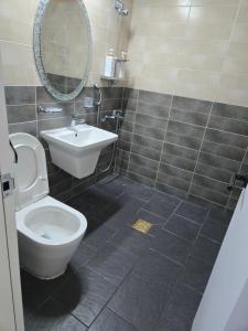 a bathroom with a toilet and a sink and a mirror at T stay guesthouse in Cheongju +19 photos