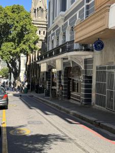 a person walking down a street next to a building at FlexiStay Hotel in Cape Town