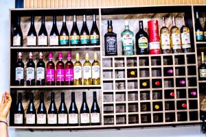 a shelf filled with lots of bottles of alcohol at Ja'oak Hotel and Suite in Mama