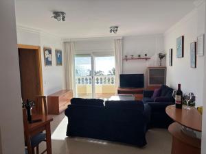 a living room with a couch and a tv at Apartamento PLAYANALA in Torrox Costa