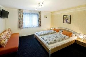 a hotel room with a bed and a couch at White Summit Appartement in Vandans