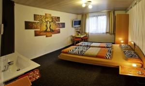 a hotel room with a bed and a sink at White Summit Appartement in Vandans