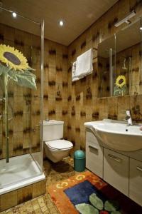 a bathroom with a toilet and a sink and a shower at White Summit Appartement in Vandans
