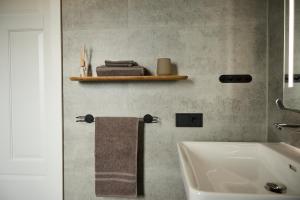 a bathroom with a sink and a towel rack at Eyri Farm in Kjósahreppur +53 photos