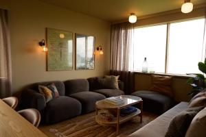a living room with a couch and a table at Eyri Farm in Kjósahreppur