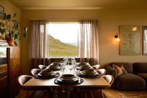 a dining room table with plates and glasses on it at Eyri Farm in Kjósahreppur
