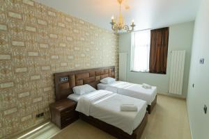 a bedroom with two beds and a wall at IREPALACE Goderdzi in Goderdzi +35 photos