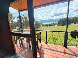 a view from the balcony of a house with a view at Cabañas finca las acacias in Guatavita +17 photos