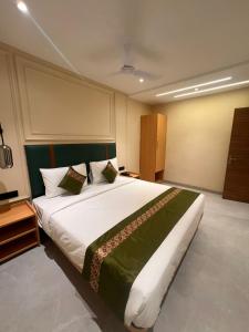 a bedroom with a large bed in a room at Kubo by Convivial Hotels in Raipur