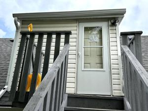 a house with a white door and a porch at Cozy Duplex 2nd floor suite in Winnipeg