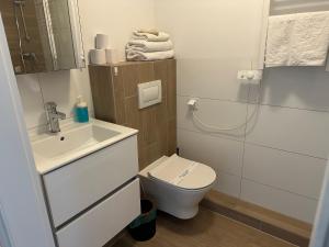 a small bathroom with a toilet and a sink at Starter III in Wrocław +36 photos