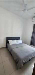 a bed with two pillows on it in a room at Spacious 4 bedroom homestay in Mersing