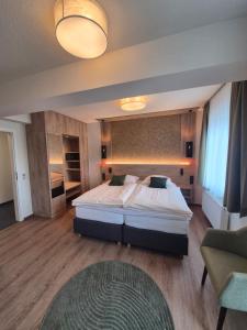 a bedroom with a large bed in a room at Hotel Restaurant Brinckwirth in Ochtrup