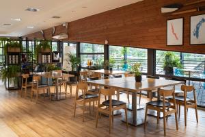a restaurant with wooden floors and tables and chairs at Hotel Termalny in Uniejow