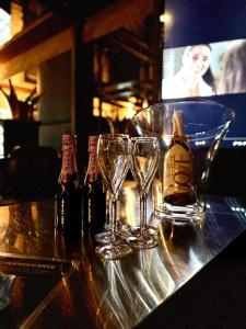 a table with glasses and bottles of alcohol on it at Secret Labelle Époque Hideaway in Berlin