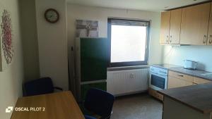 a kitchen with a green refrigerator and a window at Business Apartment Herne-Wanne in Herne +4 photos